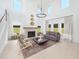 Bright living room features a fireplace, tall ceilings, and lots of natural light at 5215 Cottage Lndg Dr, Summerville, SC 29485