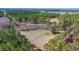 Expansive aerial view of vast wooded land, featuring cleared fields and picturesque natural landscapes at 732 Lindhaven Dr, Pineville, SC 29468