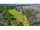 High angle view of cleared land, showcasing vibrant greenery for grazing, recreation, or development potential at 732 Lindhaven Dr, Pineville, SC 29468