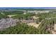 Aerial view showcasing wooded land with cleared areas and a tranquil creek, perfect for outdoor activities at 732 Lindhaven Dr, Pineville, SC 29468