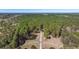 Stunning aerial view of the property with a long driveway, pond, and surrounded by lush green trees at 732 Lindhaven Dr, Pineville, SC 29468