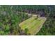Aerial view of a rectangular grassy clearing among trees, a unique private location at 732 Lindhaven Dr, Pineville, SC 29468