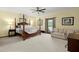 Spacious primary bedroom with sitting area, 4 poster bed, and natural light at 732 Lindhaven Dr, Pineville, SC 29468