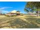 A charming single-story brick home on a large lot with a metal roof and lush, green landscaping at 732 Lindhaven Dr, Pineville, SC 29468