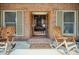 Charming front porch with double doors and rocking chairs, offering a glimpse into the home's interior at 732 Lindhaven Dr, Pineville, SC 29468