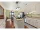 Bright kitchen with granite counters, white cabinets, island cooktop, and breakfast nook at 732 Lindhaven Dr, Pineville, SC 29468