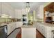 Well-lit kitchen featuring white cabinets, granite countertops, and stainless-steel appliances at 732 Lindhaven Dr, Pineville, SC 29468