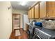 Functional laundry room featuring modern appliances, cabinets, and convenient access to an adjacent bathroom at 732 Lindhaven Dr, Pineville, SC 29468
