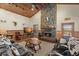 Cozy living room featuring a stone fireplace, wood ceiling, and comfortable seating arrangement at 732 Lindhaven Dr, Pineville, SC 29468