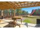 Covered wooden deck at shooting platform overlooks a tranquil forest, with US flag waving in the breeze at 732 Lindhaven Dr, Pineville, SC 29468