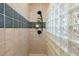 Bright shower enclosure with glass block wall, neutral tile, and a handheld shower fixture at 732 Lindhaven Dr, Pineville, SC 29468