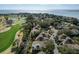 Aerial view of the golf course community showcasing lush greenery, ponds, and the ocean at 747 Spinnaker Beachhouse, Seabrook Island, SC 29455