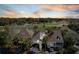 A lovely aerial view of homes on the golf course, with trees and a gorgeous sunset at 747 Spinnaker Beachhouse, Seabrook Island, SC 29455