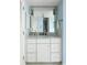 Bathroom vanity featuring a white marble countertop, an ornate mirror, and a bronze faucet at 747 Spinnaker Beachhouse, Seabrook Island, SC 29455