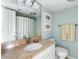 Bright bathroom featuring a marble vanity, neutral paint and white cabinets, shower and trim at 747 Spinnaker Beachhouse, Seabrook Island, SC 29455