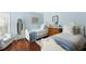 Bedroom featuring two single beds, a side table, wooden floors, and light blue walls at 747 Spinnaker Beachhouse, Seabrook Island, SC 29455