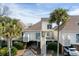 Attractive shot of the home's exterior with well-manicured landscaping and ample parking at 747 Spinnaker Beachhouse, Seabrook Island, SC 29455