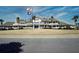 Elegant building with wrap-around porch, gabled roof, and manicured lawn, flying American and South Carolina flags at 747 Spinnaker Beachhouse, Seabrook Island, SC 29455