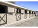 Well-maintained horse stalls with horses peering out, showcasing the equestrian facilities at 747 Spinnaker Beachhouse, Seabrook Island, SC 29455