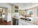 Kitchen with granite countertops with an open view to the dining room area with shuttered windows at 747 Spinnaker Beachhouse, Seabrook Island, SC 29455