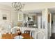 Open kitchen with granite countertops, white cabinets and view into dining area at 747 Spinnaker Beachhouse, Seabrook Island, SC 29455