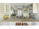 Bright kitchen features granite countertops, stainless steel appliances, and white cabinetry at 747 Spinnaker Beachhouse, Seabrook Island, SC 29455