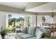 Comfortable living room with golf course view, large windows, and hardwood floors at 747 Spinnaker Beachhouse, Seabrook Island, SC 29455
