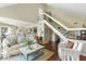 Bright, open-concept living area with hardwood floors and a staircase, blending living and dining spaces at 747 Spinnaker Beachhouse, Seabrook Island, SC 29455