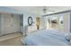 Bedroom features light blue decor, a ceiling fan, and a patio access to the outdoor terrace at 747 Spinnaker Beachhouse, Seabrook Island, SC 29455