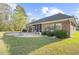 The backyard features a patio area, a screened in porch and lush green grass at 779 Hamlet Cir, Goose Creek, SC 29445