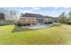 Exterior view of the home's backyard, featuring a stone patio and meticulously landscaped yard at 779 Hamlet Cir, Goose Creek, SC 29445
