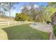 Lush backyard featuring a stone patio, green lawn, and white picket fence, ideal for outdoor enjoyment and privacy at 779 Hamlet Cir, Goose Creek, SC 29445