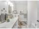 Bright bathroom with double vanity, mosaic tile, tub, and large patterned floor tiling at 779 Hamlet Cir, Goose Creek, SC 29445