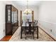 Formal dining room boasts a stylish chandelier, hardwood floors, and built-in china cabinet at 779 Hamlet Cir, Goose Creek, SC 29445