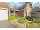 Inviting front entrance with brick pathway, manicured shrubs, and charming architectural details at 779 Hamlet Cir, Goose Creek, SC 29445