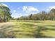 A sprawling green golf course is shown with a blue sky and wispy clouds in the background at 779 Hamlet Cir, Goose Creek, SC 29445