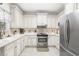 Bright eat-in kitchen features white cabinets, modern stainless appliances, and tiled backsplash at 779 Hamlet Cir, Goose Creek, SC 29445
