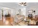 Open-concept living room showcasing hardwood floors, elegant furnishings, and a view into the dining area at 779 Hamlet Cir, Goose Creek, SC 29445