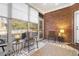 Relaxing sun room featuring exposed brick wall, lots of natural light, and cozy seating arrangements at 779 Hamlet Cir, Goose Creek, SC 29445