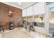 Bright sun room with brick accent wall, multiple windows, and comfortable seating, perfect for relaxation at 779 Hamlet Cir, Goose Creek, SC 29445