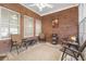 Inviting sun room with brick walls, large windows, and comfortable seating, ideal for leisure and entertaining at 779 Hamlet Cir, Goose Creek, SC 29445