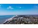 Coastal community aerial view featuring homes nestled amongst trees and the oceanfront at 8 Fairway Oaks Ln, Isle of Palms, SC 29451