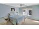 Comfortable bedroom with light blue walls, ceiling fan, and a large window at 8 Fairway Oaks Ln, Isle of Palms, SC 29451
