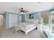Relaxing bedroom with light blue walls, ceiling fan, white trim, and cozy window seating at 8 Fairway Oaks Ln, Isle of Palms, SC 29451