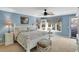 Comfortable bedroom featuring neutral carpet, white trim, coastal decor, and light blue walls at 8 Fairway Oaks Ln, Isle of Palms, SC 29451