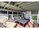 Outdoor deck offering comfortable seating, a large table, and overhead coverage from the sun at 8 Fairway Oaks Ln, Isle of Palms, SC 29451