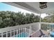 This deck offers overhead coverage from the sun while overlooking the pool and treetops at 8 Fairway Oaks Ln, Isle of Palms, SC 29451