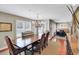 Elegant dining room featuring a large wooden table, chandelier, and ample natural light at 8 Fairway Oaks Ln, Isle of Palms, SC 29451