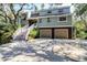 Attractive two-story home with a two-car garage, inviting stairway, and lush landscaping at 8 Fairway Oaks Ln, Isle of Palms, SC 29451