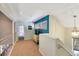 Beautiful hallway featuring three windows and a decorative pendant light at 8 Fairway Oaks Ln, Isle of Palms, SC 29451